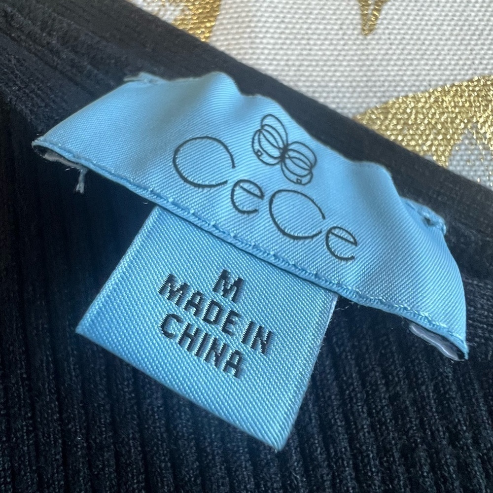 CeCe Black Sweater with Gold Accents
Caja 6 - Picture 4 of 4